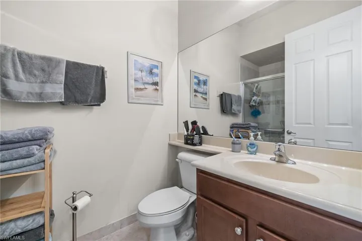 Bathroom featuring vanity, and enclosed shower on main level