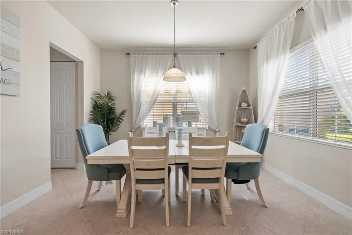 Tiled dining area featuring a wealth of natural light