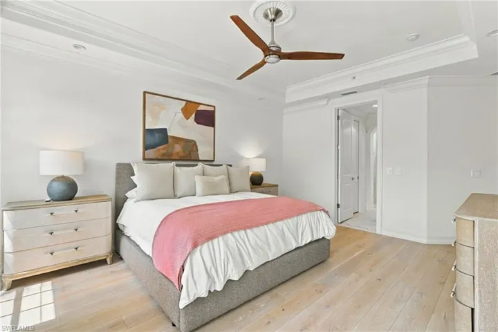 Recessed lighting, crown molding, wood-finish flooring, ceiling fan, and a built-in door frame