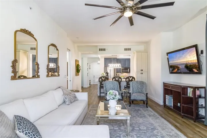 Living room with wood-type flooring and ceiling fan