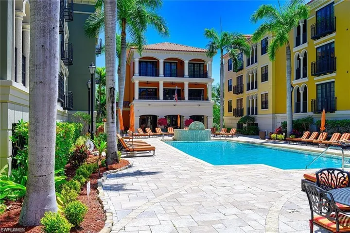 View of pool with a patio area and pool water feature
