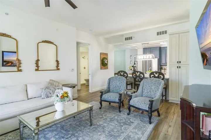 Living room featuring ceiling fan and hardwood / wood-style floors