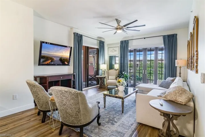 Living room with hardwood / wood-style flooring, ceiling fan, and french doors