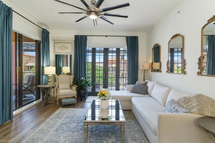 Living room featuring a wealth of natural light, hardwood / wood-style flooring, ceiling fan, and french doors