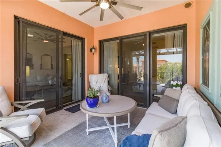 View of terrace with outdoor lounge area and ceiling fan