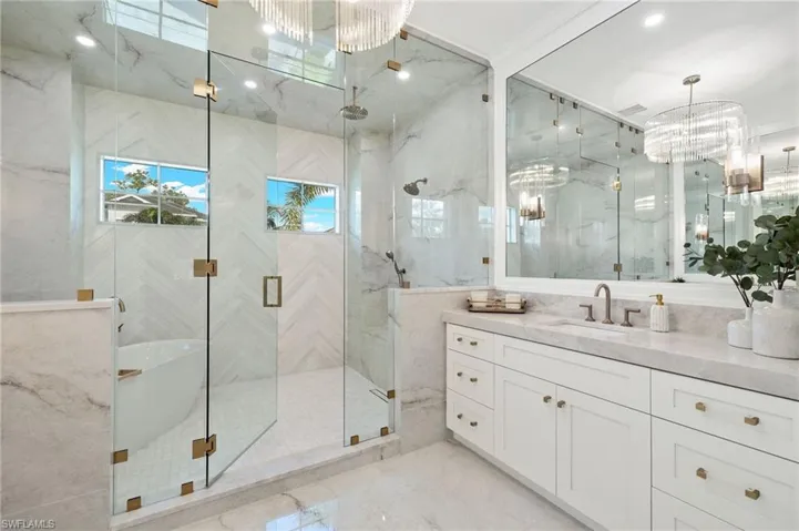 Bathroom featuring vanity and a shower with shower door