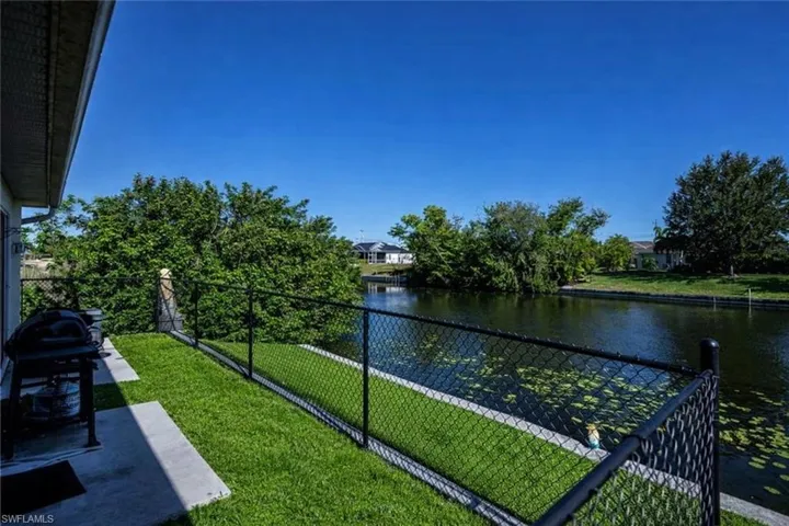 Balcony with area for grilling and a water view