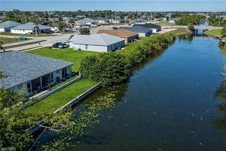 Aerial perspective of suburban area featuring a nearby body of water