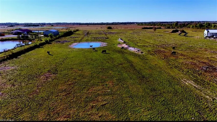 Aerial view featuring a water view and a rural view