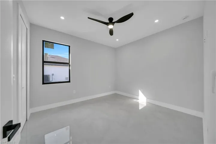 Spare room with concrete floors, ceiling fan, and recessed lighting