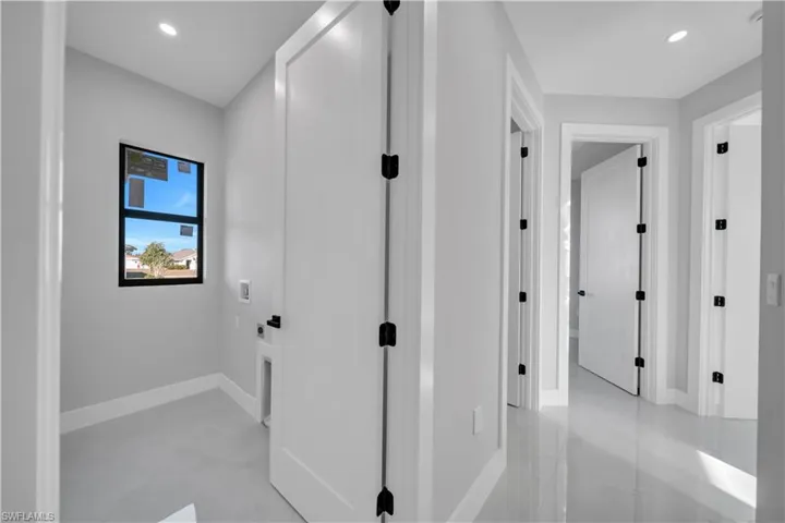 Hallway with recessed lighting and concrete flooring