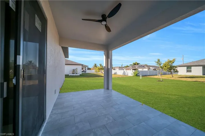 View of patio with a ceiling fan and a residential view