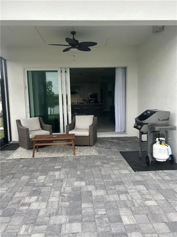 View of patio featuring area for grilling and ceiling fan