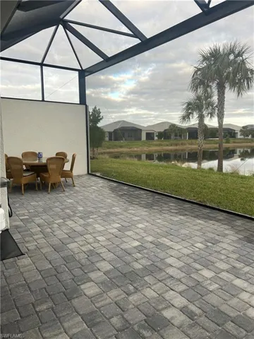 Sunroom featuring a water view