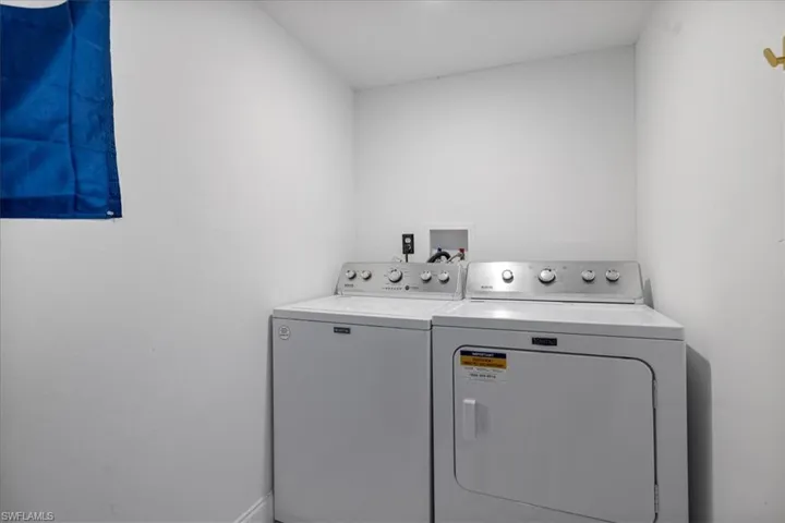 Downstairs Laundry with huge storage space below stairs