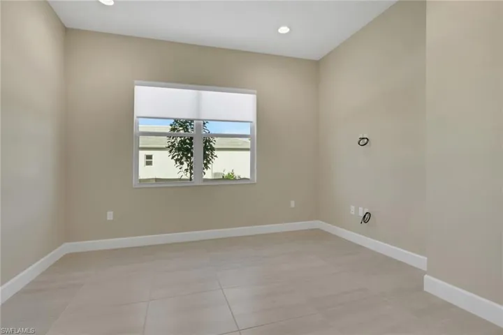 Unfurnished room featuring light tile patterned floors and recessed lighting