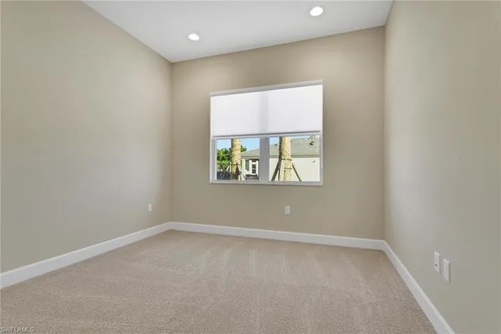 Bedroom with light colored carpet