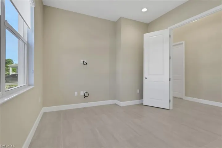 Unfurnished room with recessed lighting and light tile patterned floors