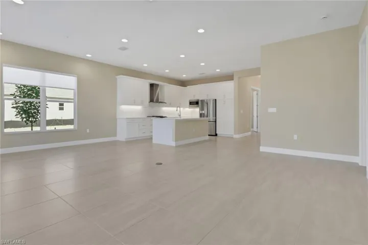 Unfurnished living room with recessed lighting and light tile patterned floors