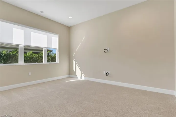 Empty room featuring light carpet and recessed lighting