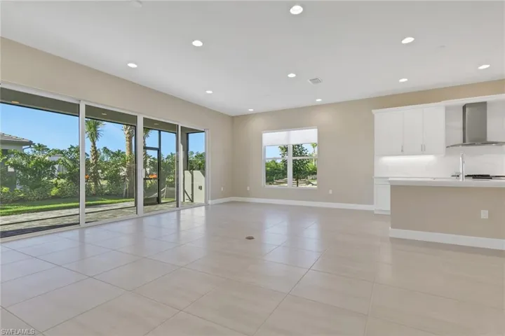 Unfurnished living room with recessed lighting and light tile patterned flooring