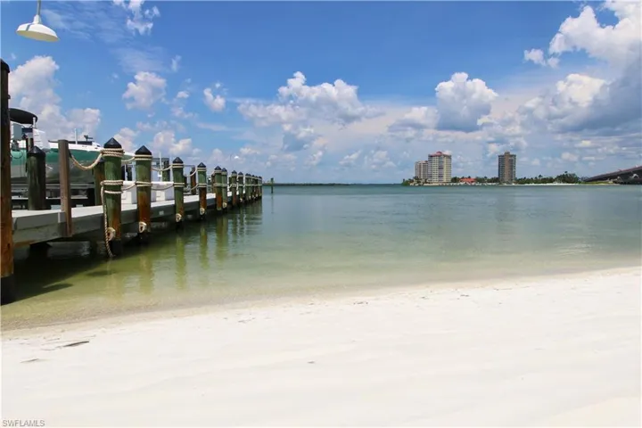 Water view with a dock and nearby beach