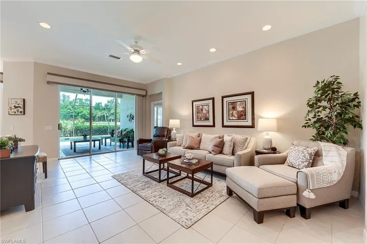 Living room featuring ceiling fan, ornamental molding, light tile patterned flooring, recessed lighting, and baseboards