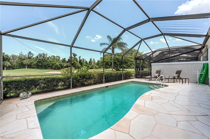 Swimming pool featuring a patio and glass enclosure