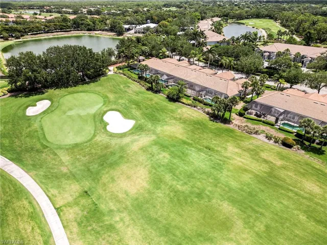 Aerial perspective of suburban area with a large body of water and a local golf course