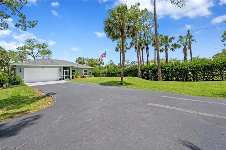 View of front of home featuring driveway, an attached garage, and stucco siding