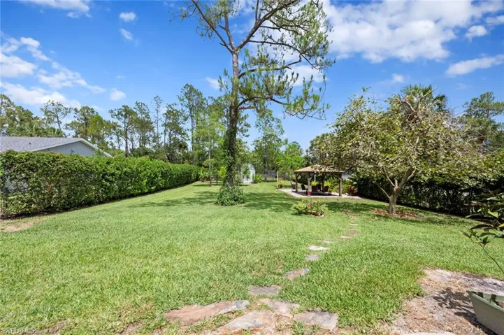 View of green lawn featuring a patio area and a gazebo