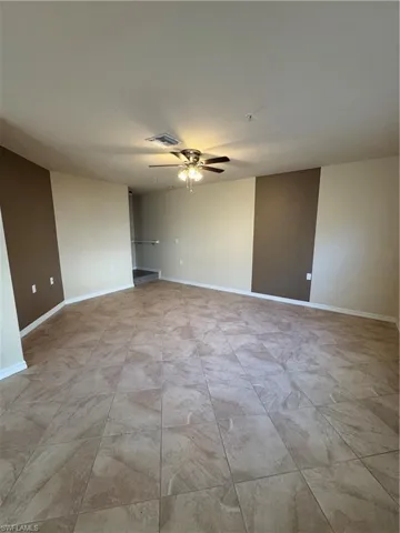 Unfurnished room with baseboards and ceiling fan