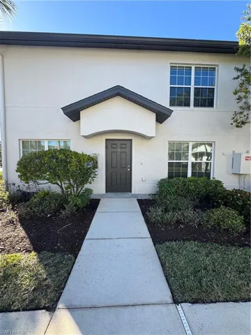 Doorway to property featuring stucco siding