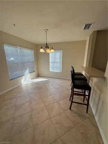 Dining room with hanging lights and healthy amount of natural light