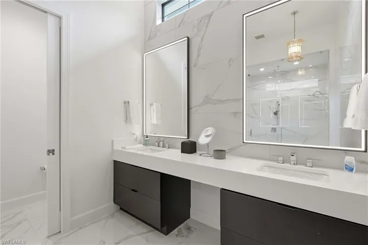 Dual vanity with integrated sinks and white countertops