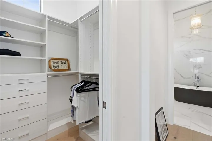 Custom-built closet system with shelving, drawers, and hanging rods