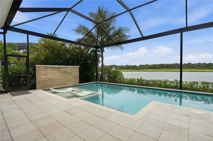 Screened lanai featuring a private pool with sun shelf, paver decking, a water feature, and panoramic water scenery