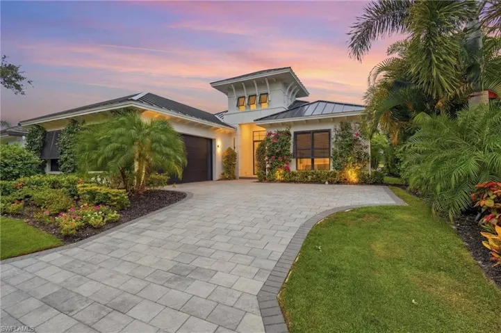 Contemporary architectural design with white stucco exterior and dark shingle roofing