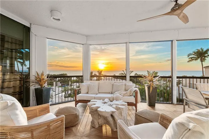 Sunroom featuring a water view and ceiling fan
