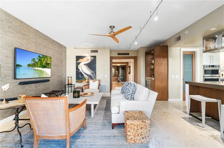 Living room with ceiling fan and track lighting