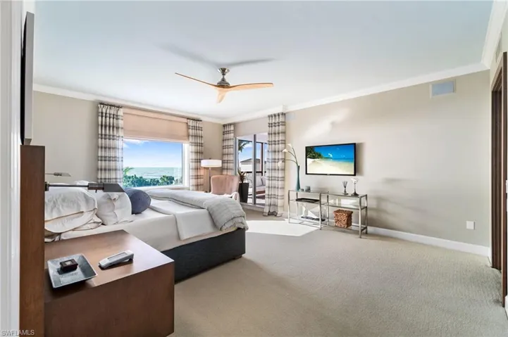 Bedroom featuring carpet flooring, ornamental molding, and ceiling fan