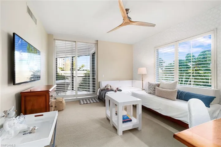 Carpeted living room featuring ceiling fan