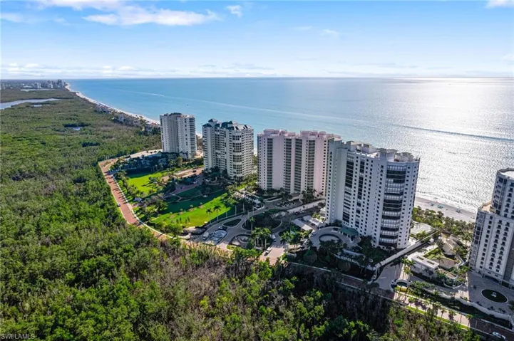 Birds eye view of property with a water view