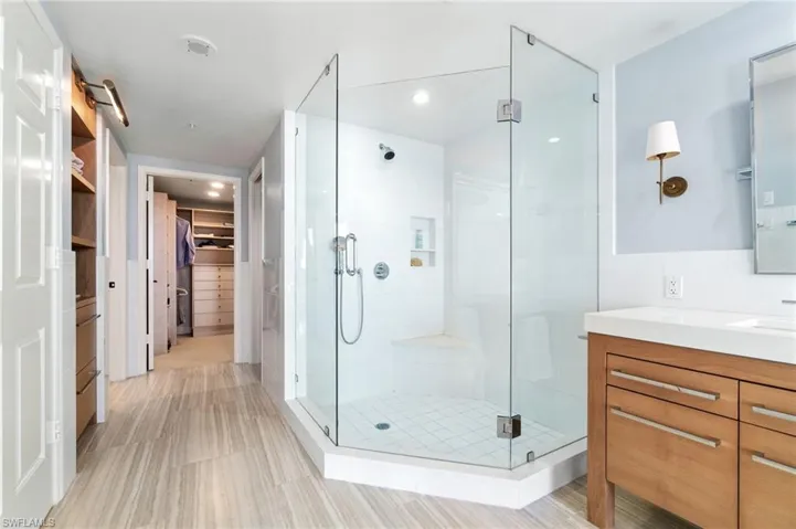 Bathroom featuring vanity and an enclosed shower
