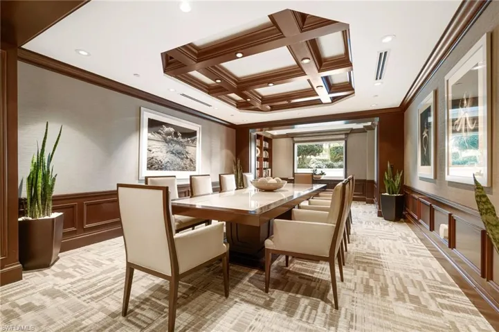 Conference room featuring coffered ceiling, beam ceiling, and ornamental molding