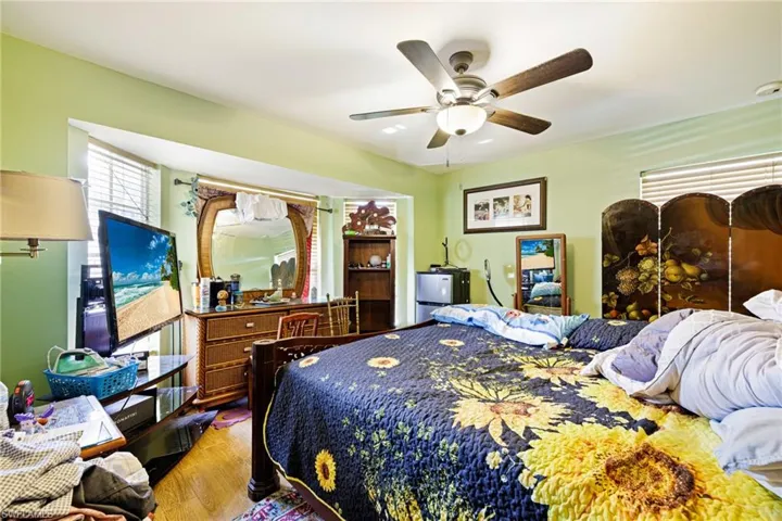 Bedroom featuring wood finished floors and ceiling fan