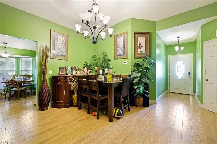 Dining space featuring a chandelier and wood finished floors