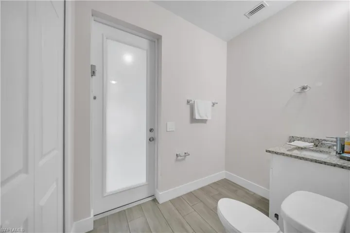 Bathroom with vanity and wood tiled floors