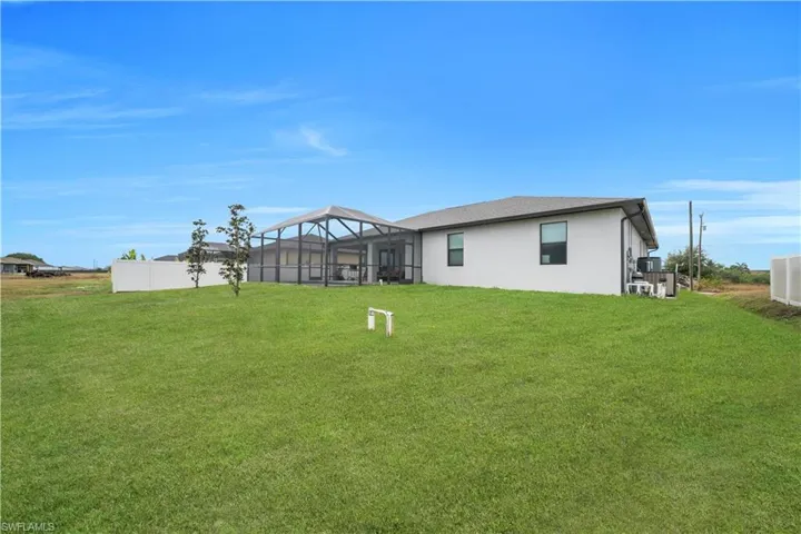 Back of property featuring a lanai, stucco siding, and a sunroom