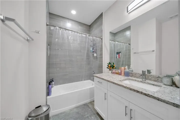 Full bath with vanity and shower / bath combination with curtain